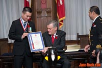 Paul Nguyen and Lt. Gov. David C. Onley inspect the award